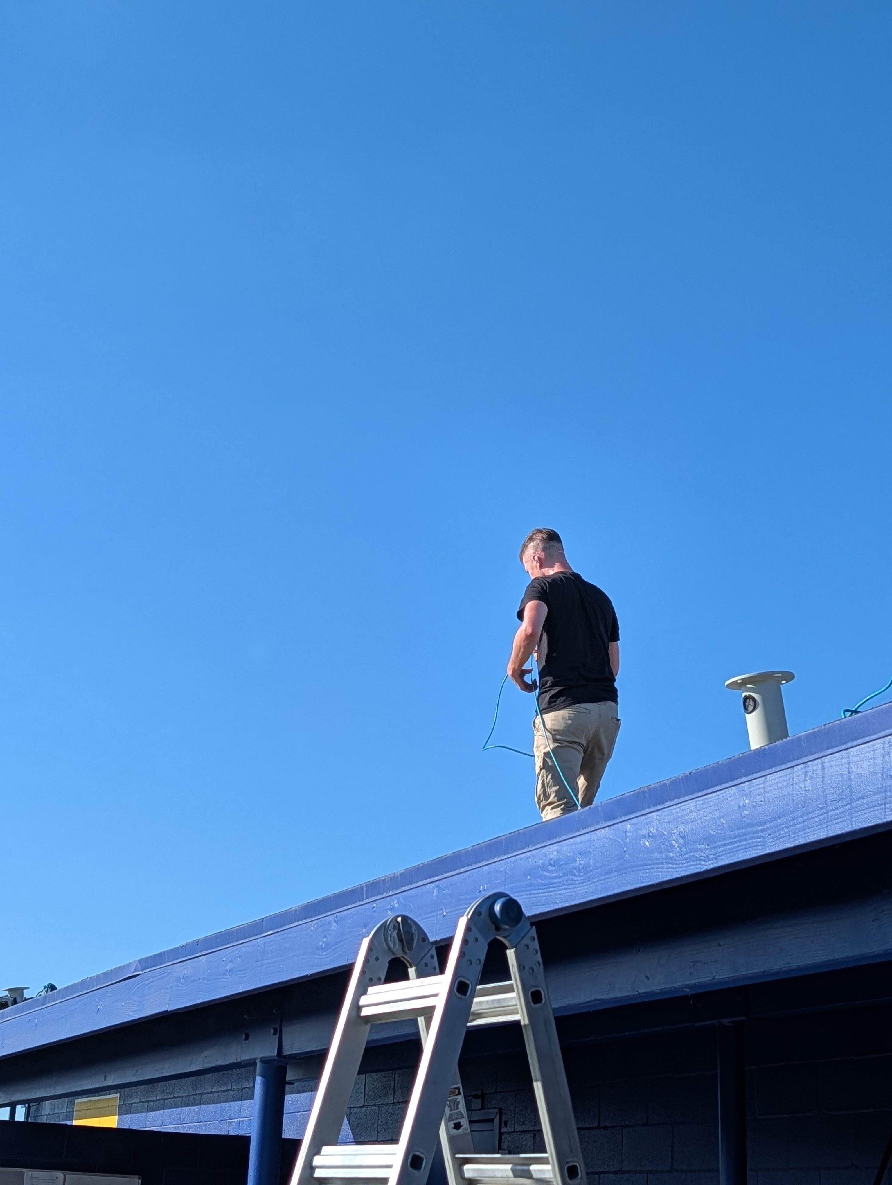 KnC technician working beside an installed sports-field camera